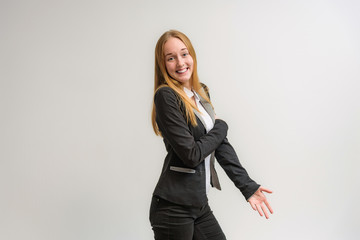 Studio portrait on the camera of a smiling beautiful girl with long hair talking on a white background with emotions.