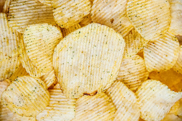 Potato chips corrugated background top view, close-up