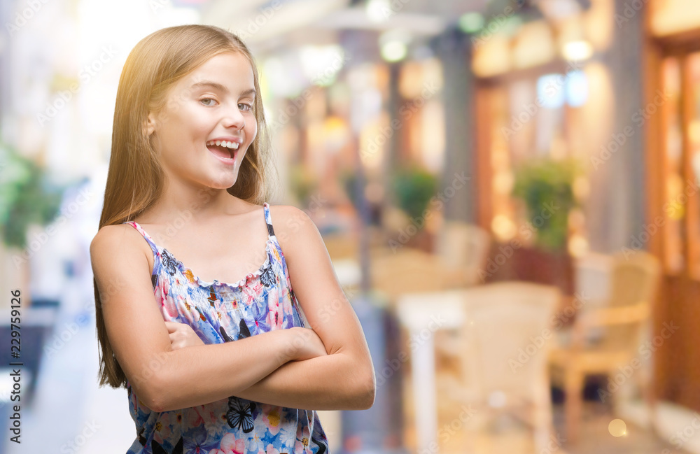 Wall mural young beautiful girl wearing colorful dress over isolated background happy face smiling with crossed