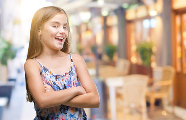 Young beautiful girl wearing colorful dress over isolated background happy face smiling with crossed arms looking at the camera. Positive person.