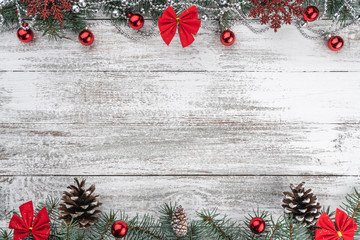 Garlands, baubles, snowflakes and other holiday items. Fir branches and cones. Xmas greeting card. Old wooden Christmas background. Top view. Space for your text.