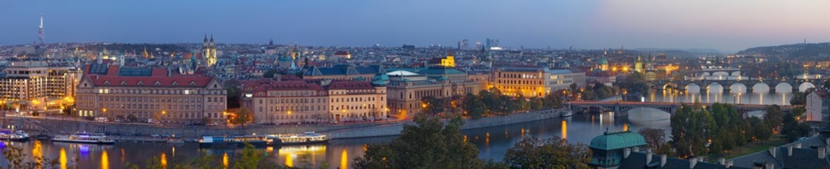 Fototapeta na wymiar Prague - The panorama of the city with the bridges at dusk.