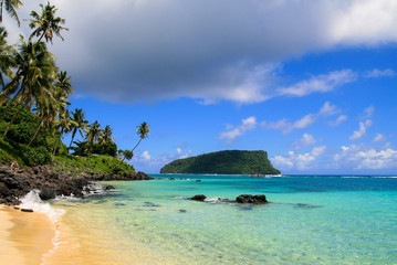 Paradise tropical beach in Pacific Ocean with turquoise water, golden sand and exotic palm trees. Idyllic holiday escape, view from Lalomanu beach in Upolu to Nu’utele island, Samoa