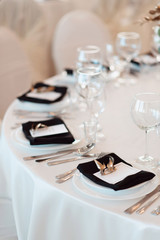 Sparkling glassware stands on table prepared for wedding. Wedding decor, interior. Festive. Banquet table