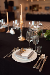 Sparkling glassware stands on table prepared for wedding. Wedding decor, interior. Festive. Banquet table