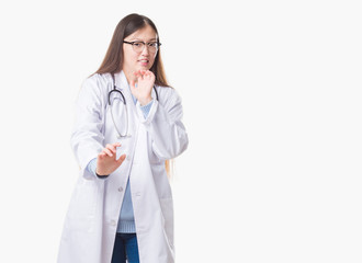 Young Chinese doctor woman over isolated background disgusted expression, displeased and fearful doing disgust face because aversion reaction. With hands raised. Annoying concept.