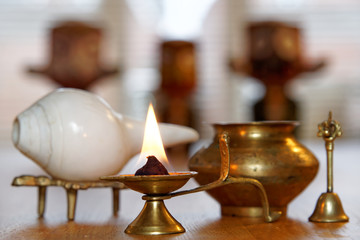 Burning a ghee candle with Puja set and Hindu deity Lord Jagannath in the blurry background © padmak