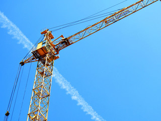 Construction crane. Self-erection crane against blue sky. Building crane.