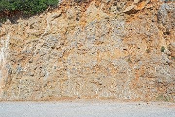 Mountain slope near the dirty sandy road