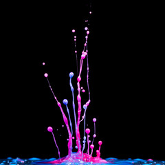 splash of color fluid ink on black background