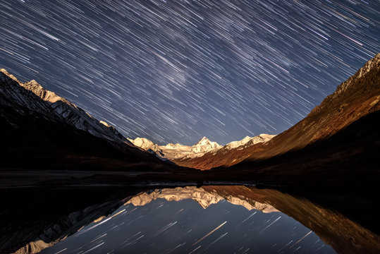 star tracks mountains lake sky reflection