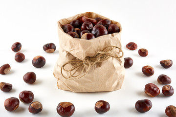 Chestnuts in paper bag on white background