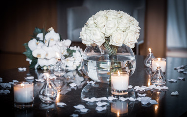 Bouquet of roses on wedding table with candles