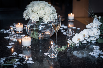 Bouquet of roses on wedding table with candles