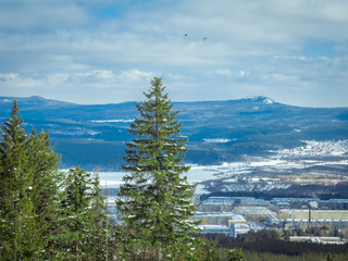beautiful mountain winter landscape. in the valley of the mountains is the city. people live...