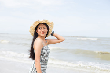 young pretty asian woman enjoy her freedom on the tropical beach