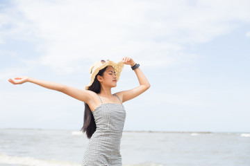Fototapeta na wymiar young pretty asian woman enjoy her freedom on the tropical beach