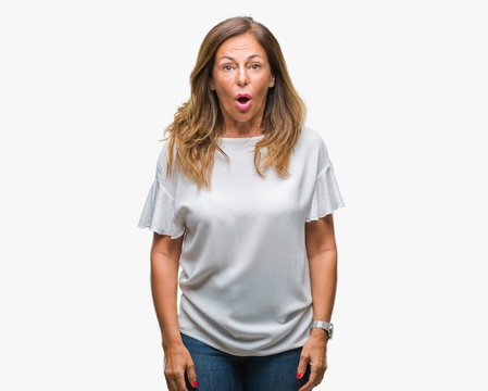 Middle age senior hispanic woman over isolated background afraid and shocked with surprise expression, fear and excited face.