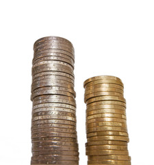 Columns of coins, piles of coins on white background, one and two euro pieces