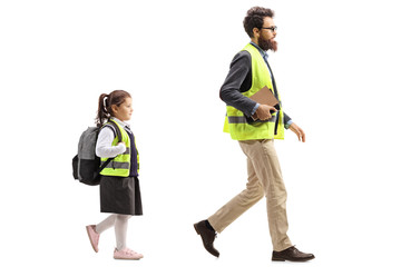 Man in a safety vest and a schoolgirl walking behind him
