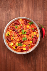 Chili con carne, traditional Mexican dish, with a chili pepper, shot from the top with a place for text