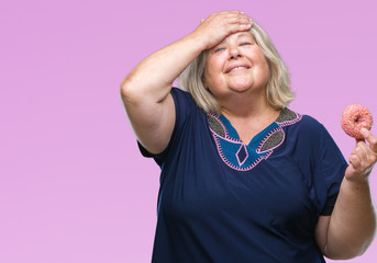 Senior plus size caucasian woman eating sugar donut over isolated background stressed with hand on...