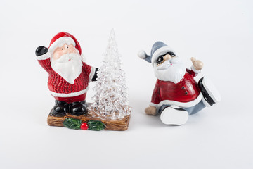Shiny ceramic retro santa ornament . holding a lantern with Christmas tree at the base of the stautue.