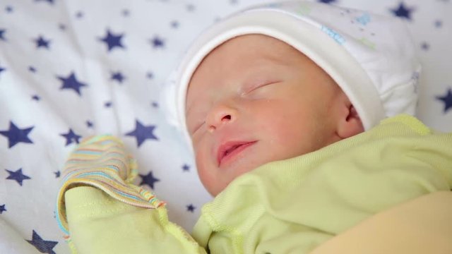 Close-up of cute newborn baby sleeping in delivery room. Portrait of a sleeping newborn baby.