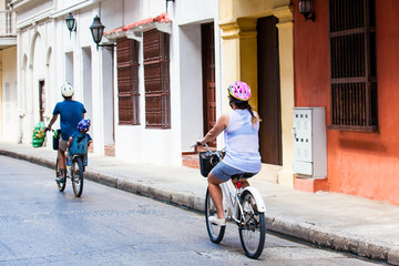 Family riding on rental bikes around the walled city in Cartagena de Indias