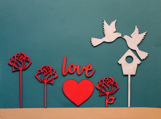valentines day card with wooden figures of birds,hearts, roses,flat lay top view