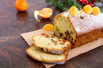 Christmas cake with nuts, dried fruit, tangerines. Traditional festive pastries.