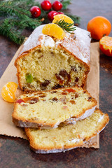 Christmas cake with nuts, dried fruit, tangerines. Traditional festive pastries.