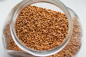 Grain of buckwheat in a glass jar, top view_