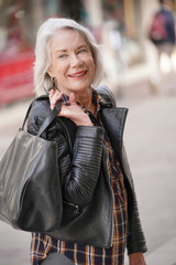  Modern senior woman in town wearing leather jacket