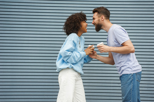 Beautiful girl and caucasian hipster guy in urban setting
