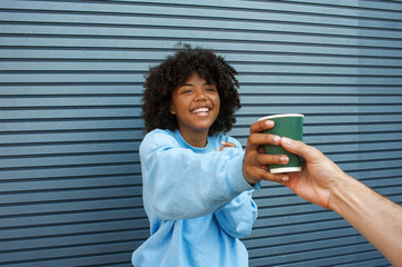 Cute girl is given coffee on a street