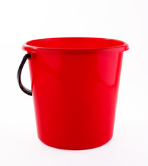 Red plastic bucket on white background