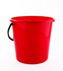 Red plastic bucket on white background © Наталья Купрейченко