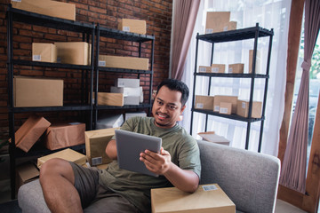 man using tablet selling product online
