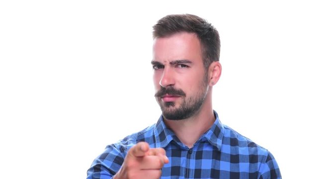 Young adult bearded man pointing at camera dissatisfied and scolding finger isolated on white background. 