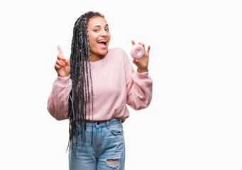 Obraz premium Young african american girl eating pink donut over isolated background surprised with an idea or question pointing finger with happy face, number one
