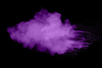 Abstract purple powder explosion on black  background. Freeze motion of purple dust particle...