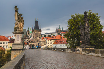 Rainy day view over Charles bridge in Prague. Perfect day for umbrella sightseeing