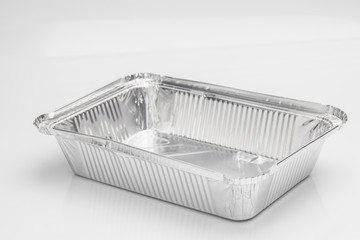 Foil food delivery container with reflection isolated over the white background