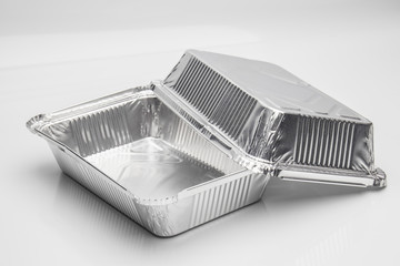 Foil food delivery container with reflection isolated over the white background