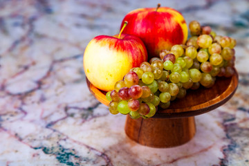 Grapes and apples in a wooden bowl