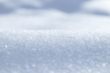 Snow crystals and snowflakes background close up macro white and blue in good view sparkling in the sun. Selective focus.Wallpaper. Poster