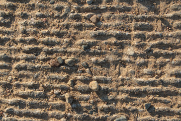 Rough Grey Sunlit Concrete Background Texture With Lines and Small Stones