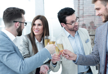 close up.business people celebrate with champagne