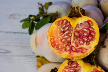 Fototapeta na wymiar Pomegranate fruit on a wooden plate
